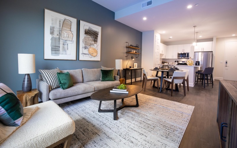 living room with furniture table and view of a kitchen